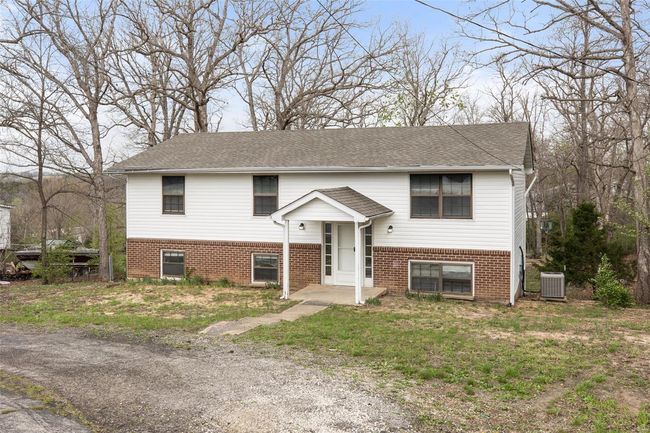 Raised ranch with brick siding, central AC unit, and roof with shingles | Image 38