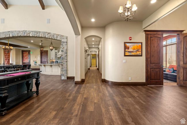 Entrance foyer with dark wood-style flooring, recessed lighting, arched walkways, and a notable chandelier | Image 28
