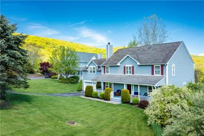 View of front facade with a front yard and covered porch | Image 1