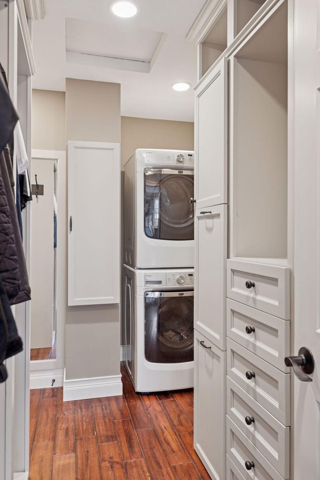 Master Closet has built in's, washer, dryer, and drop down ironing area. | Image 20
