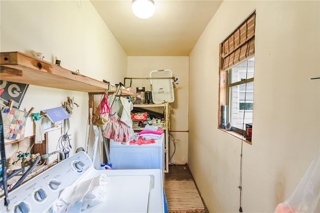 Laundry room featuring washer and clothes dryer and wood finished floors | Image 30