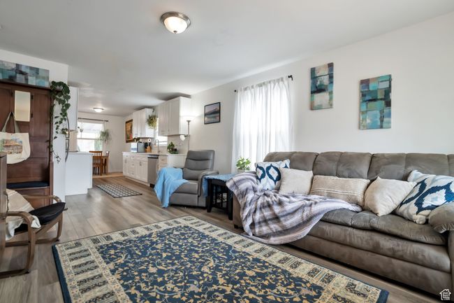 Living room with light wood-style floors | Image 7