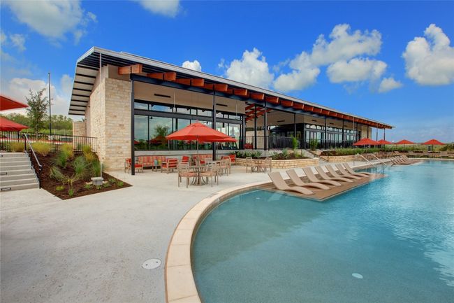 A resort-style pool with beach entry, tanning ledges and plenty of shaded seating offers a retreat from the summer heat. | Image 10