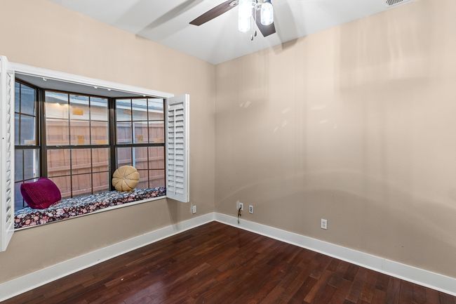Unfurnished room featuring dark wood-type flooring, baseboards, and a ceiling fan | Image 12