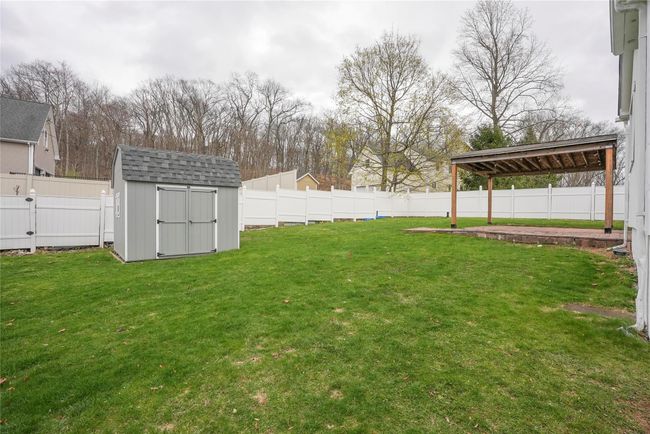 View of yard featuring a fenced backyard, an outbuilding, and a shed | Image 22