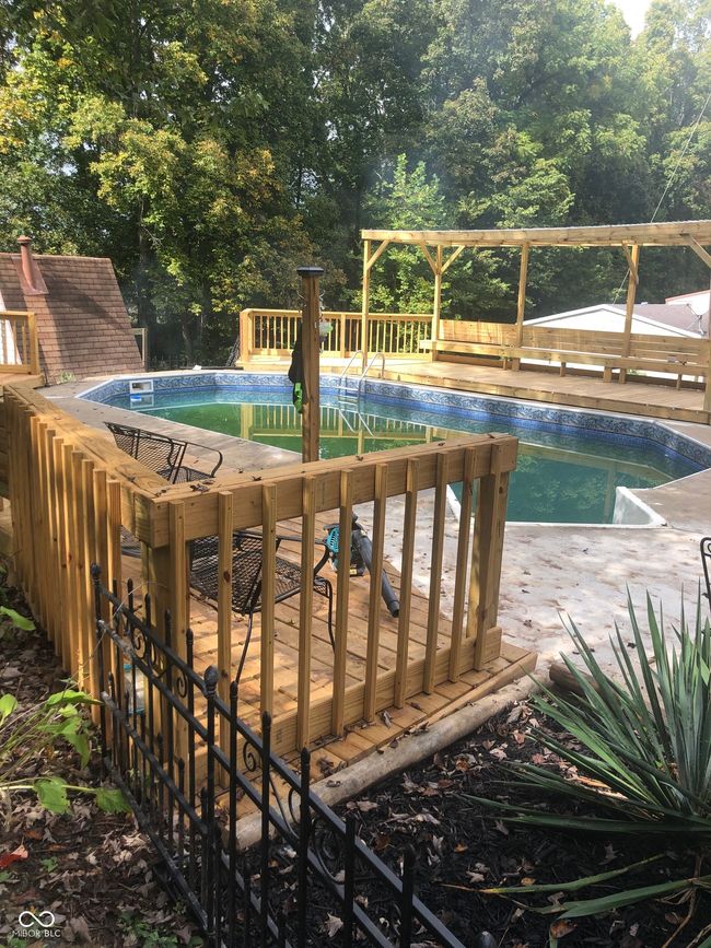 outdoor pool with view of scattered trees | Image 5