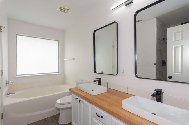 Primary Bath includes updated vessel sinks and butcher block counter | Image 17