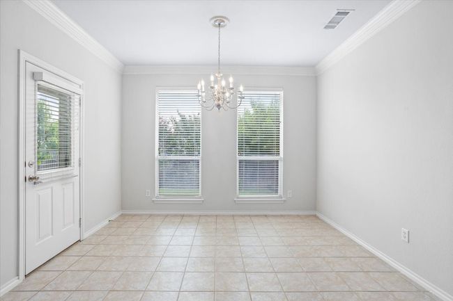 Large dining area with large windows overlooking the pretty back yard | Image 10