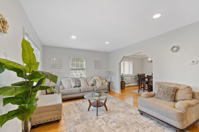 Living area featuring recessed lighting, arched walkways, baseboards, and light wood-type flooring | Image 7