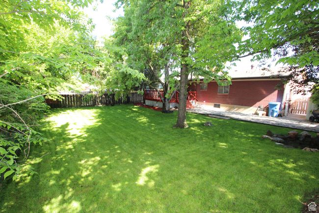 View of yard with a wooden deck | Image 5