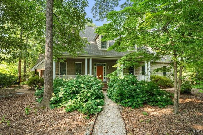 New england style home featuring a porch and a shingled roof | Image 43