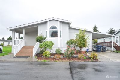 Spacious front sitting porch with park and parking next to it. Large carport with wheelchair ramp. Remove that for under cover parking. | Image 3