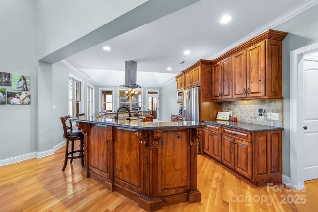 Adjacent to the kitchen the hallway will lead you to a large pantry, kitchen accessory storage closet, office/craft room, half bath, huge laundry room, stairs up to the F.R.O.G, side home entrance and two car attached garage. | Image 12