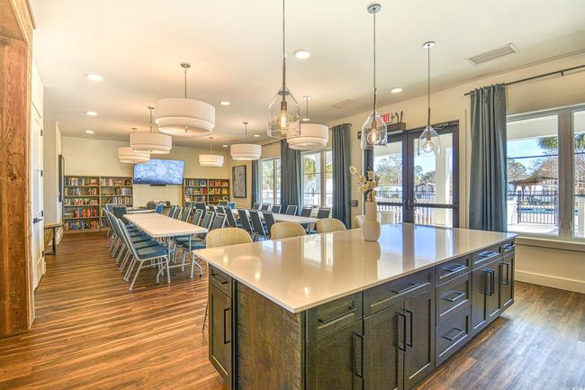 Kitchen featuring dark hardwood / wood-style flooring, a wall unit AC, pendant lighting, and a kitchen island | Image 10
