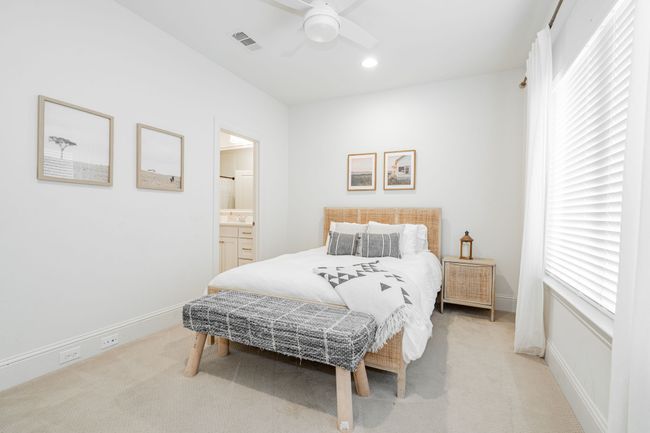 Bedroom with queen sized bed, ceiling fan, light colored carpet, ensuite Jack and Jill bath, and decor. | Image 28