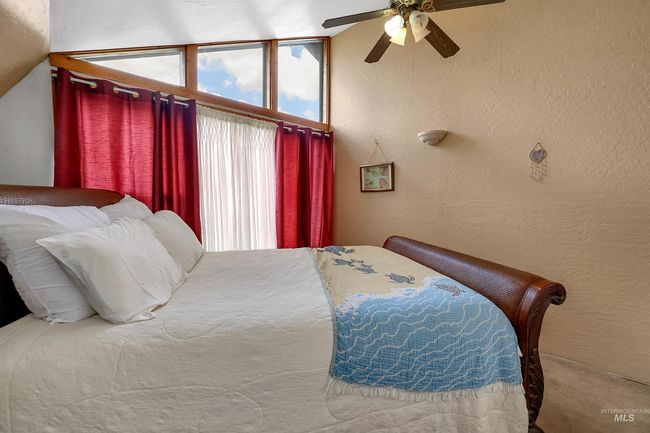 Bedroom featuring a ceiling fan, a textured wall, and carpet floors | Image 35
