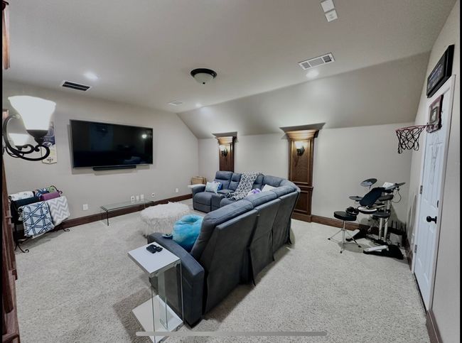 Cinema featuring light carpet and lofted ceiling | Image 18
