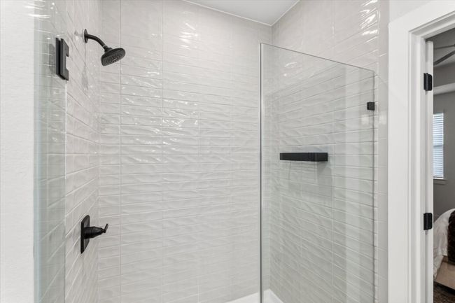 Bathroom featuring tiled shower | Image 14