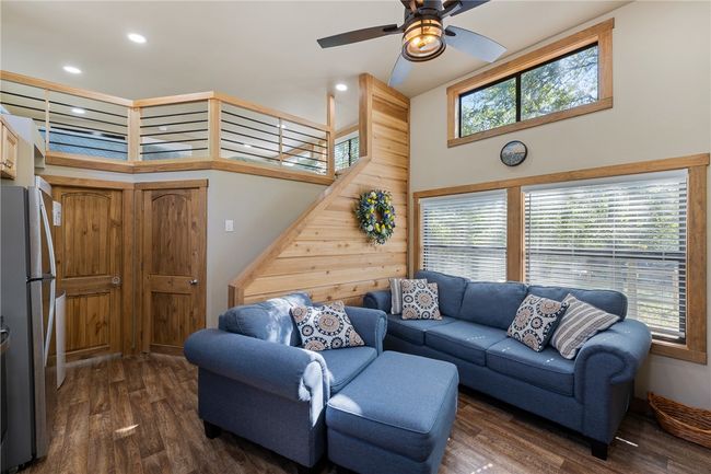 Living area with dark wood-style flooring, a ceiling fan, and recessed lighting | Image 6