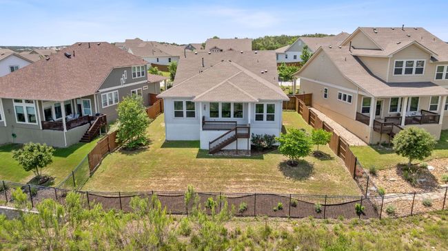 Featuring wood privacy fencing along the sides and wrought iron along the back to preserve the views. | Image 34