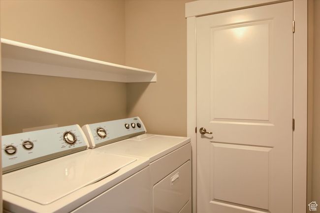 Laundry room featuring laundry area and washing machine and clothes dryer | Image 22