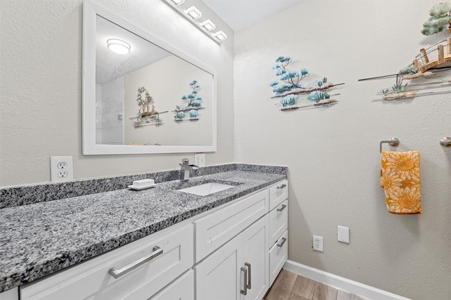 Bathroom with wood finished floors, vanity, and baseboards | Image 24