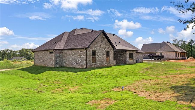 Back of property featuring brick siding, a lawn, and a shingled roof | Image 4
