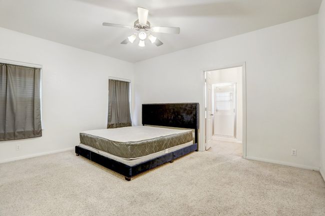 Carpeted bedroom with baseboards and a ceiling fan | Image 10