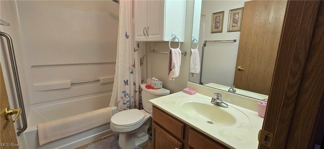 Bathroom with toilet, shower / bath combo, and vanity | Image 22