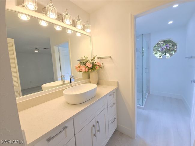 Bathroom with a stall shower, vanity, and baseboards | Image 20