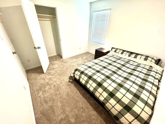 Bedroom featuring carpet and a closet | Image 11