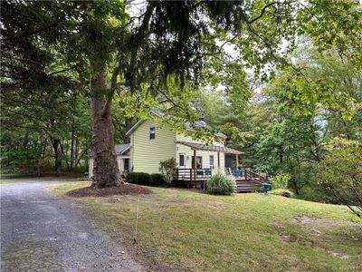 View of front of home featuring a deck and a front lawn | Image 2