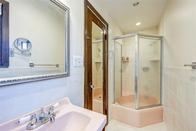Full bathroom with tile walls, an enclosed shower, tile patterned floors, recessed lighting, and a wainscoted wall | Image 20