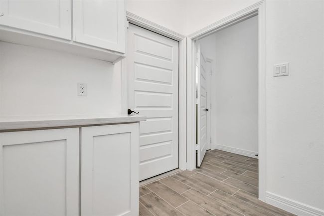 Utility room, Door opening to garage with extra cabinets and counter space | Image 11