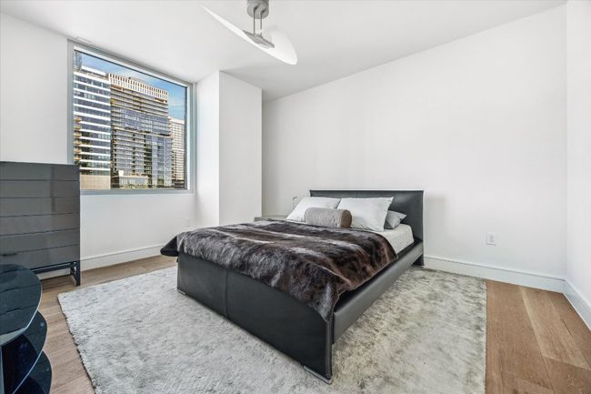 Bedroom with wood finished floors and baseboards | Image 7