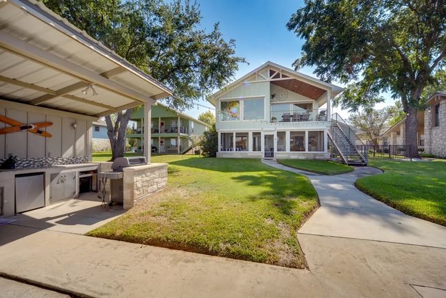 View of front of property featuring stairway, a front yard, and a balcony | Image 10