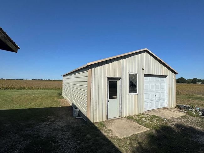 Garage featuring a rural view and a lawn | Image 25