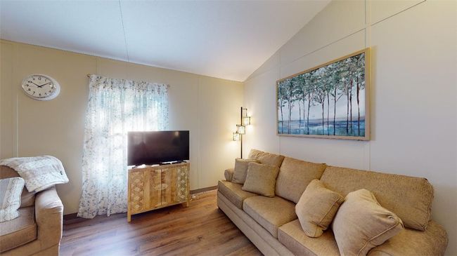 Living room featuring wood finished floors and lofted ceiling | Image 21