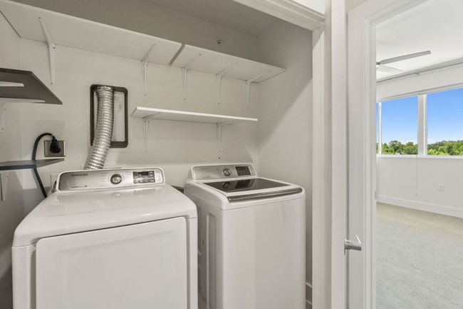 Full size washer and dryer located on the 3rd level at the top of the stairs just outside the primary bedroom | Image 20