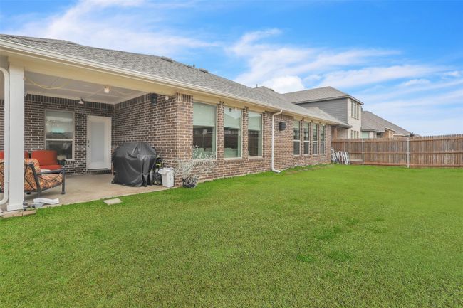 Back of house featuring a lawn and a patio area | Image 32