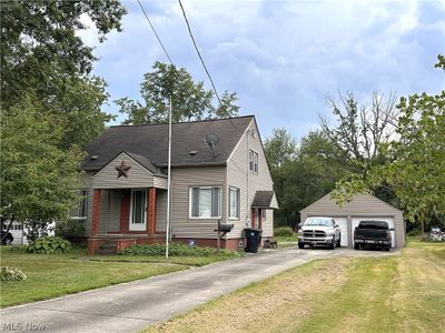 View of front facade featuring a garage | Image 1