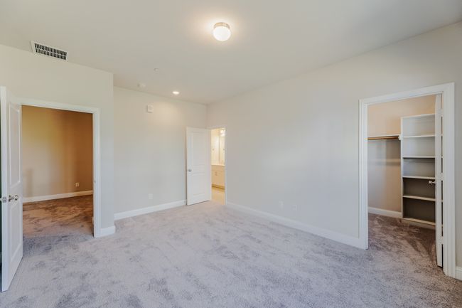 Unfurnished bedroom with carpet, a spacious closet, and recessed lighting | Image 17
