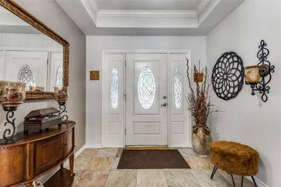 Entryway with a raised ceiling and crown molding | Image 3