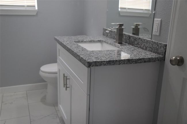 Granite vanity with undermounted basin. | Image 17
