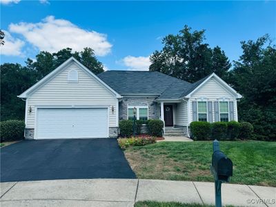 View of front of home featuring a garage and a front lawn | Image 1