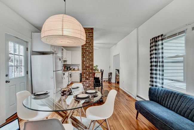 Dining area with a baseboard radiator and light wood-style flooring | Image 7
