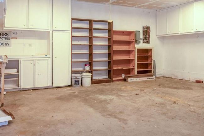 Garage has extra shelving for storgae & a transfer switch installed | Image 16