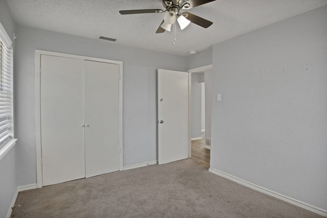 Unfurnished bedroom featuring visible vents, a textured ceiling, a closet, carpet floors, and baseboards | Image 17