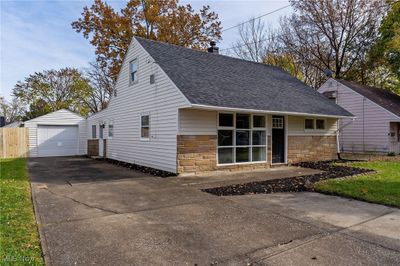 View of front facade featuring an outdoor structure and a garage | Image 2