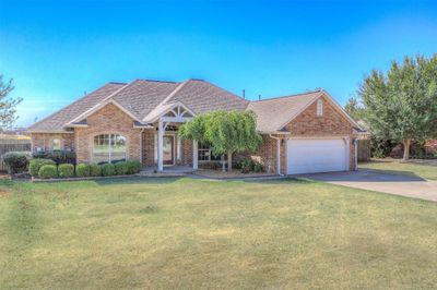 View of front facade with a front lawn and a garage | Image 2